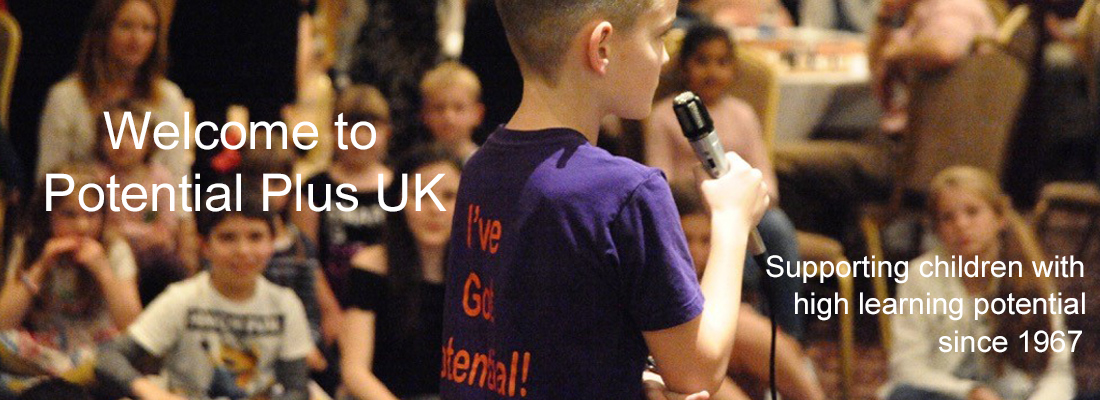 boy with microphone and a tshirt that says "I've got potential" addressing a group of children at a Potential Plus UK Big Family Weekend